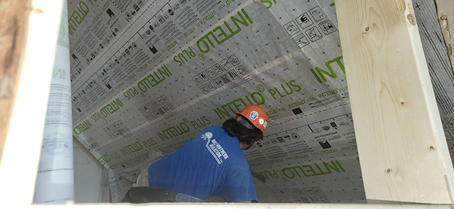 A Great Northern Insulation employee prepares a ceiling for cellulose insulation install